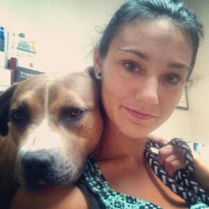 Sabrielle Melton, head trainer and owner of The Canine's Voice in Wheaton, IL with well trained dog